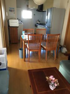Tokai民泊Ｒｉｋａ的一间带桌椅的客厅和一间厨房