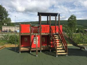 耶卢Øen Turistsenter Cottages的屋顶上配有红色游戏设备的游乐场