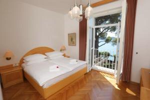 斯楚雅Vila Tartini的一间卧室设有一张床和一个大窗户