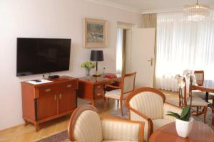 斯楚雅Vila Tartini的客厅配有电视和桌椅