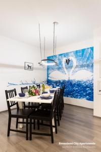罗瓦涅米罗瓦涅米城市公寓的餐桌、椅子和天鹅画