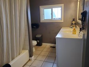 格罗夫兰优胜美地国际青年旅舍的一间带水槽和卫生间的浴室以及窗户。