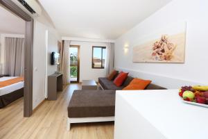 帕尔马海滩碧玉公寓的客厅配有床和沙发