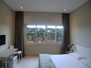 卡利亚里B&Beach Cagliari guest house的一间卧室设有一张床和一个大窗户