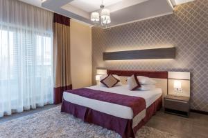 马马亚新辉煌酒店及Spa - 仅限成人（16岁以上）的酒店客房设有一张床和一个大窗户