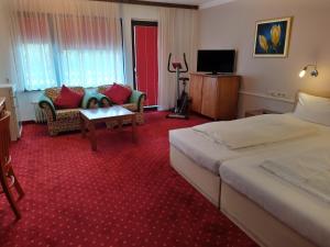 布莱特瑙Hotel Faller的酒店客房,设有两张床和一张沙发