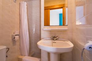 圣安东尼奥费雷尔旅馆的一间带水槽、镜子和卫生间的浴室