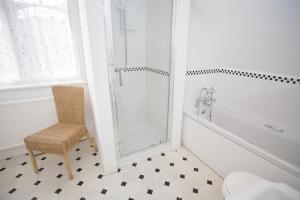 迪尔逊尼克罗夫特旅馆的带淋浴、椅子和卫生间的浴室