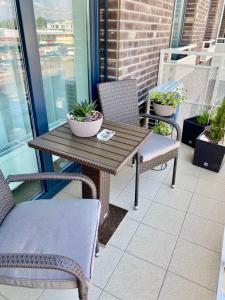 布拉迪斯拉发Die Oase - Luxurious Apartment near the City Center的阳台上的木桌和椅子