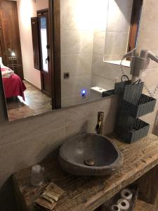 拉武埃尔达方达卡雷拉宾馆的一间带石制水槽和镜子的浴室