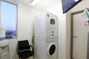 拉巴斯万巴斯酒店的一个带椅子的房间的洗衣机和烘干机
