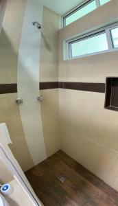 埃斯孔迪多港Lidxi Rosae的带窗户的浴室内的淋浴间