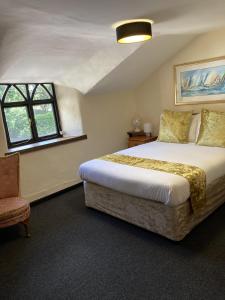 Trusham克列福特宾馆的一间卧室配有一张大床和一把椅子