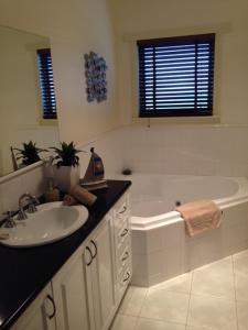 沃纳姆堡榕树上的海风酒店的浴室配有盥洗盆和浴缸。