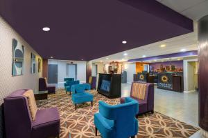 孟菲斯孟菲斯机场雅园拉昆塔酒店及套房的一间设有蓝色椅子的等候室和一间酒吧