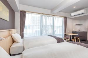 Hotel GOCO stay Kyoto Shijo Kawaramachi客房内的一张或多张床位