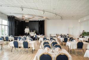 齐斯泰兹里姆湾酒店的宴会厅配有白色的桌子和蓝色的椅子