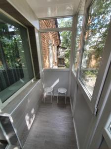 克洛佩夫尼茨基Apartment on Tarkovskogo 2的阳台配有两把椅子和两扇窗户