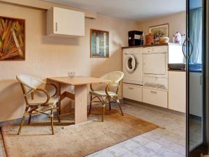 伦讷2 person holiday home in R nne的厨房配有木桌、椅子和水槽