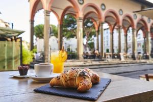 佛罗伦萨乐坎德拉邱比酒店的桌上放着面包和咖啡