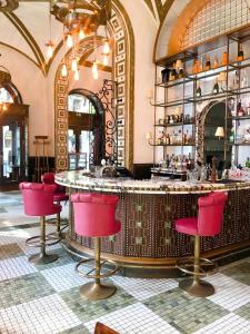 布达佩斯卡拉斯之家酒店的餐厅内的酒吧,带红色椅子