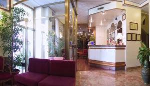米兰梅尔卡酒店的大堂设有紫色沙发和酒吧