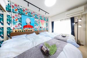 名古屋Mezon Etowaaru的一间卧室设有两张床和大屏幕