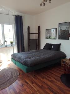 瑟德港Gårdshuset的一间卧室配有一张床,铺有木地板