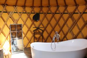 Conchez-de-Béarnyourtes coccinelles的帐篷内带浴缸的浴室