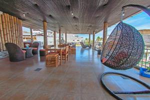 阿约拉港Hostal Costa del Pacifico的一间带桌椅和秋千的房间