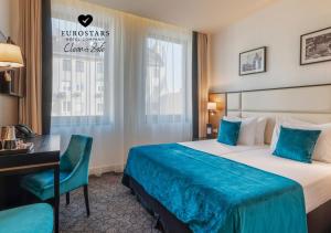 布达佩斯布达佩斯多瑙河欧洲之星酒店的配有一张床和一张书桌的酒店客房