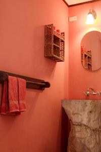 Curubandé卡萨鲁拉阿罗玛坎普酒店的浴室提供红色毛巾、镜子和水槽
