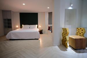 曼谷Silom Apartment Close to BTS +WIFI+Netflix的卧室配有白色的床和椅子