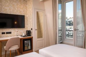巴黎香榭丽舍酒店的配有一张床、一张书桌和一扇窗户的酒店客房