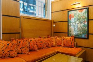 普罗夫迪夫Hotel Avion - Self check in的一张大橙色沙发,坐在房间里