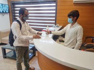 新德里Airport Hotel Delhi Aerocity的两个戴面具的人站在柜台