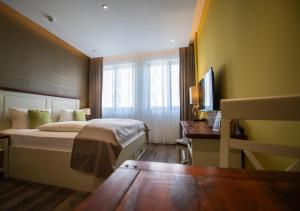莱比锡莱比锡中央公寓式酒店的配有一张床和一张书桌的酒店客房