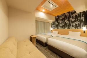 Tosei Hotel Cocone Ueno Okachimachi客房内的一张或多张床位