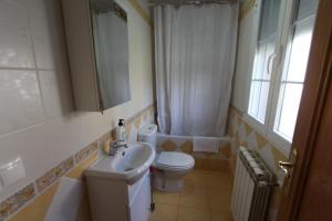 MuñecaLas Riendas casa rural的一间带水槽和卫生间的浴室以及窗户。