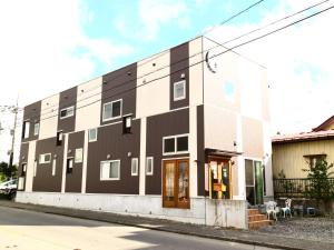 富士吉田市ホステル富士山 結的街道边的黑白建筑