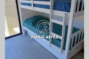 皮里亚波利斯BAHIA SAN FRANCISCO, casa Gaviotas, a 80 metros del mar, Uruguay的客房设有带绿色枕头的双层床。