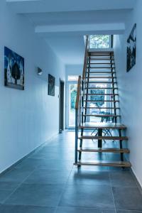 毛科Marusius Apartmanház的一间铺有瓷砖地板的客房内的楼梯