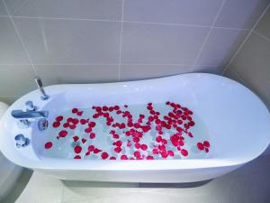 咸阳Lavande Hotel Xianyang Yuquan Road Wanda Plaza Branch的白色浴缸内有红色的心