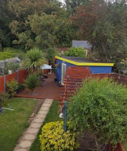 KentMango Lodge的花园,带五颜六色的棚子和甲板