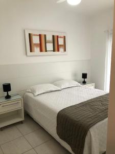 圣劳伦斯海滨Ilha da Madeira Resort - Cobertura com Jacuzzi的卧室配有一张床,墙上设有镜子