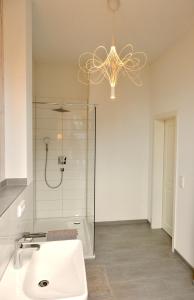 汉堡豪斯德公寓的带淋浴、水槽和吊灯的浴室