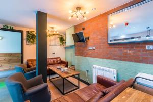 爱丁堡CoDE Co-Living – The LoFT - Edinburgh的带沙发和砖墙的客厅