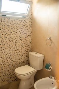坎帕纳莫拉达套房酒店的一间带卫生间、窗户和水槽的浴室