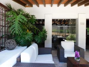 阿特利斯科Hotel & Spa Luna Canela Boutique的庭院配有白色家具和植物