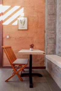 塞隆贝拉纳克第七避风港酒店的一张桌子和一把靠墙的椅子